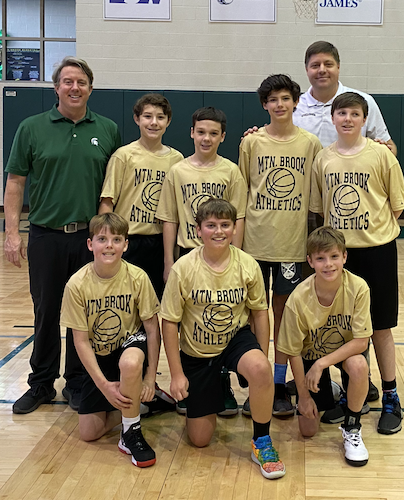Josh (far left) with his 50th team coached, a youth basketball team